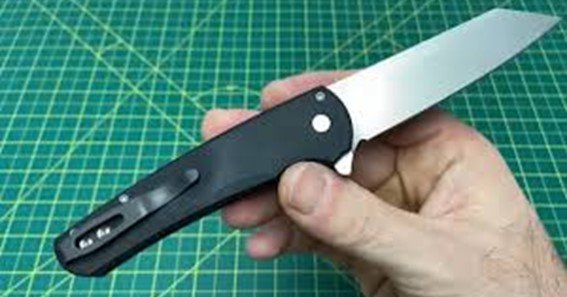 who invented the button lock on knives